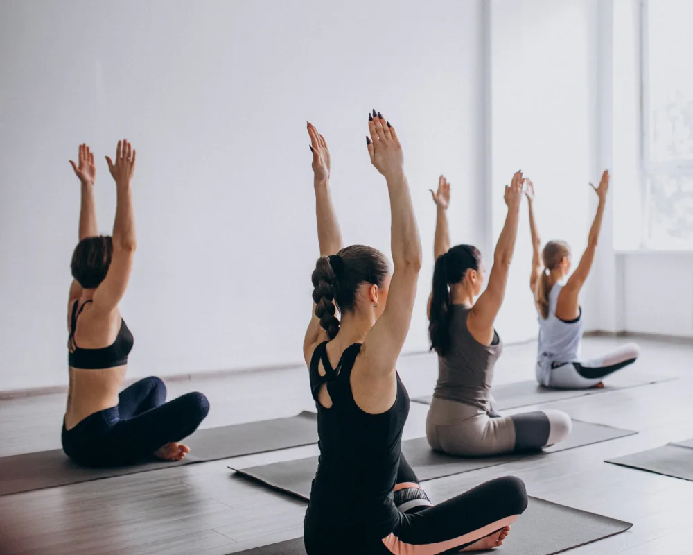 Women’s Fitness Clubs of Canada Ajax members participating in a calming yoga class, focusing on flexibility, balance, and mindfulness in a supportive women-only studio environment.